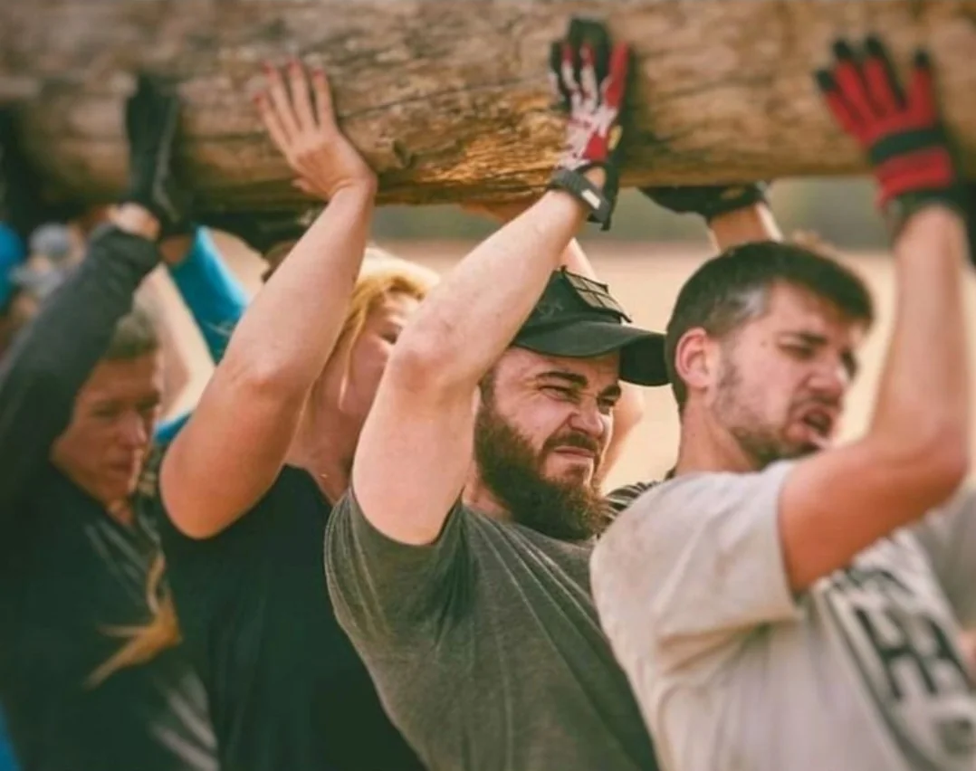 Team carrying a heavy log together